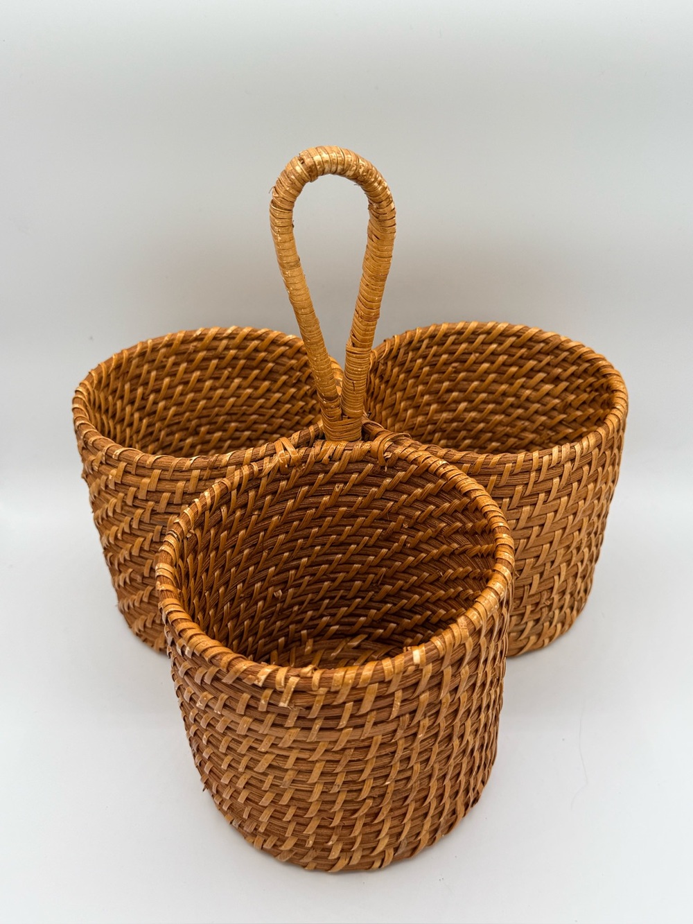 Vintage three-compartment woven rattan caddy/basket with a central loop handle
